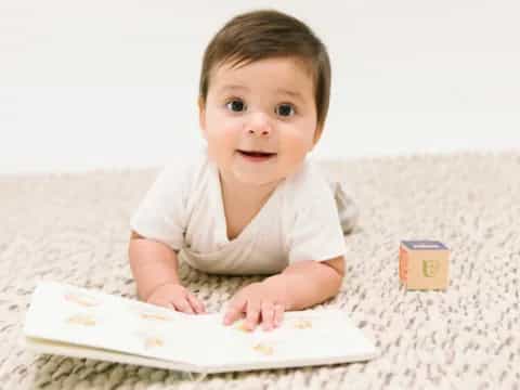 a baby lying on a bed