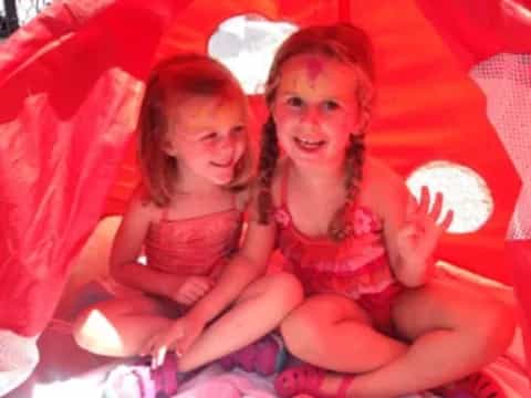 two girls sitting on a couch
