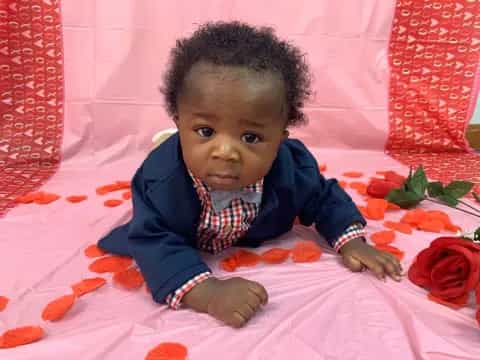 a baby lying on a blanket