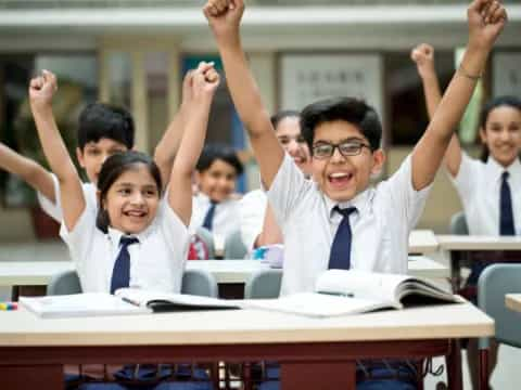 a group of students raising their hands