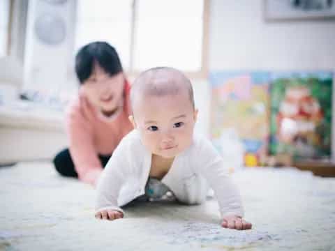 a baby crawling on the floor
