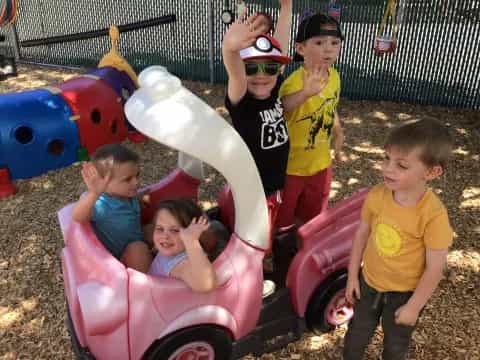 kids playing in a toy car