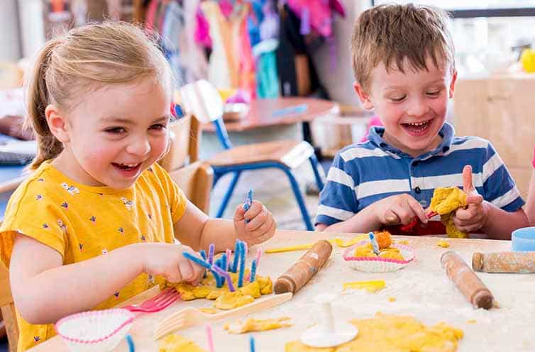 a couple of children painting
