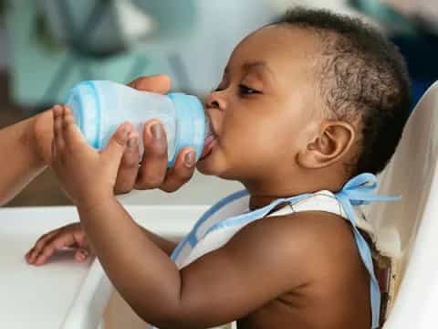 a baby drinking from a bottle
