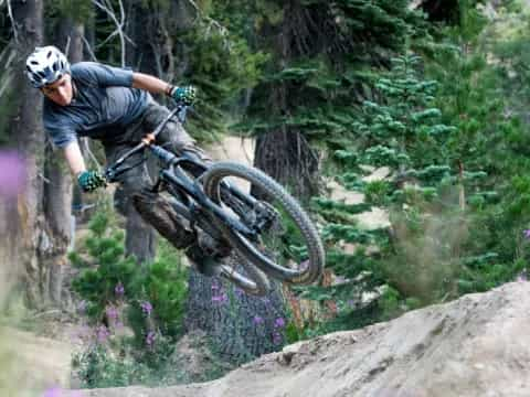 a man riding a bike on a rock