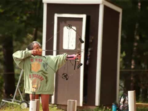 a person shooting a bow and arrow