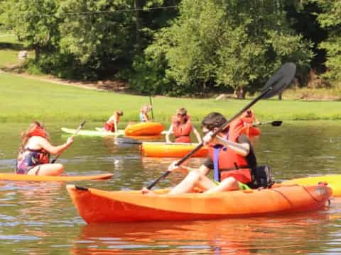 a group of people in canoes