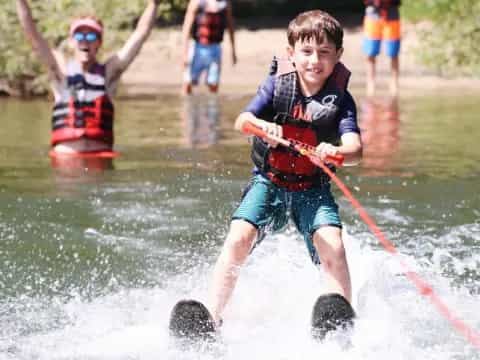 a couple of people water skiing