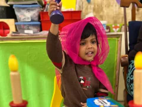 a child wearing a pink hoodie