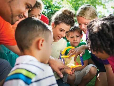 a group of people looking at a child