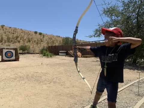 a person shooting a bow and arrow