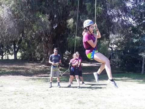 a group of people on a swing