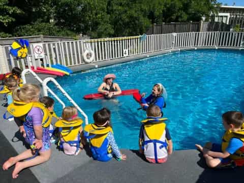 a group of kids in a pool