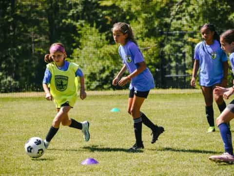 girls playing football on a field