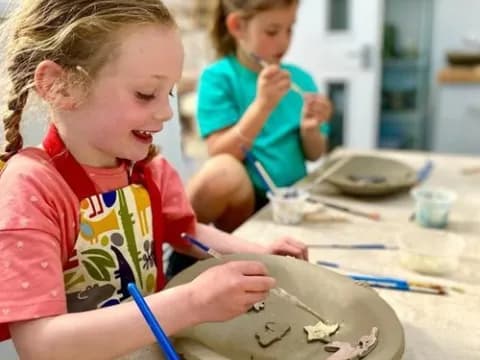 a young girl painting a picture