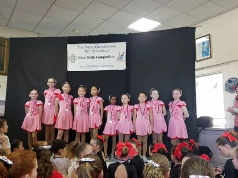 a group of girls in pink dresses
