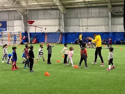a group of kids playing football