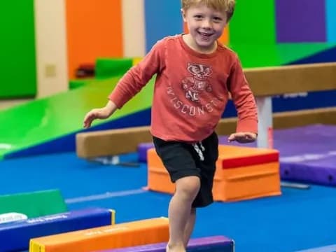 a boy standing on a mat
