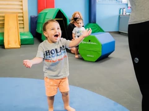 a child running on a blue mat