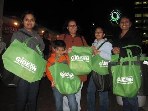 a group of people holding bags