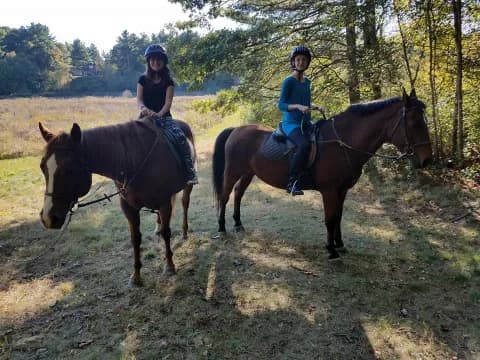 two people riding horses