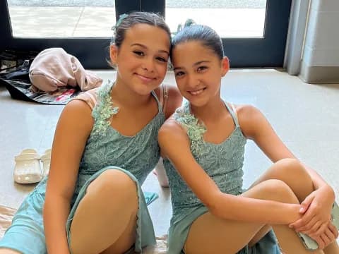 two girls sitting on the floor