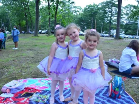 a group of girls in dresses