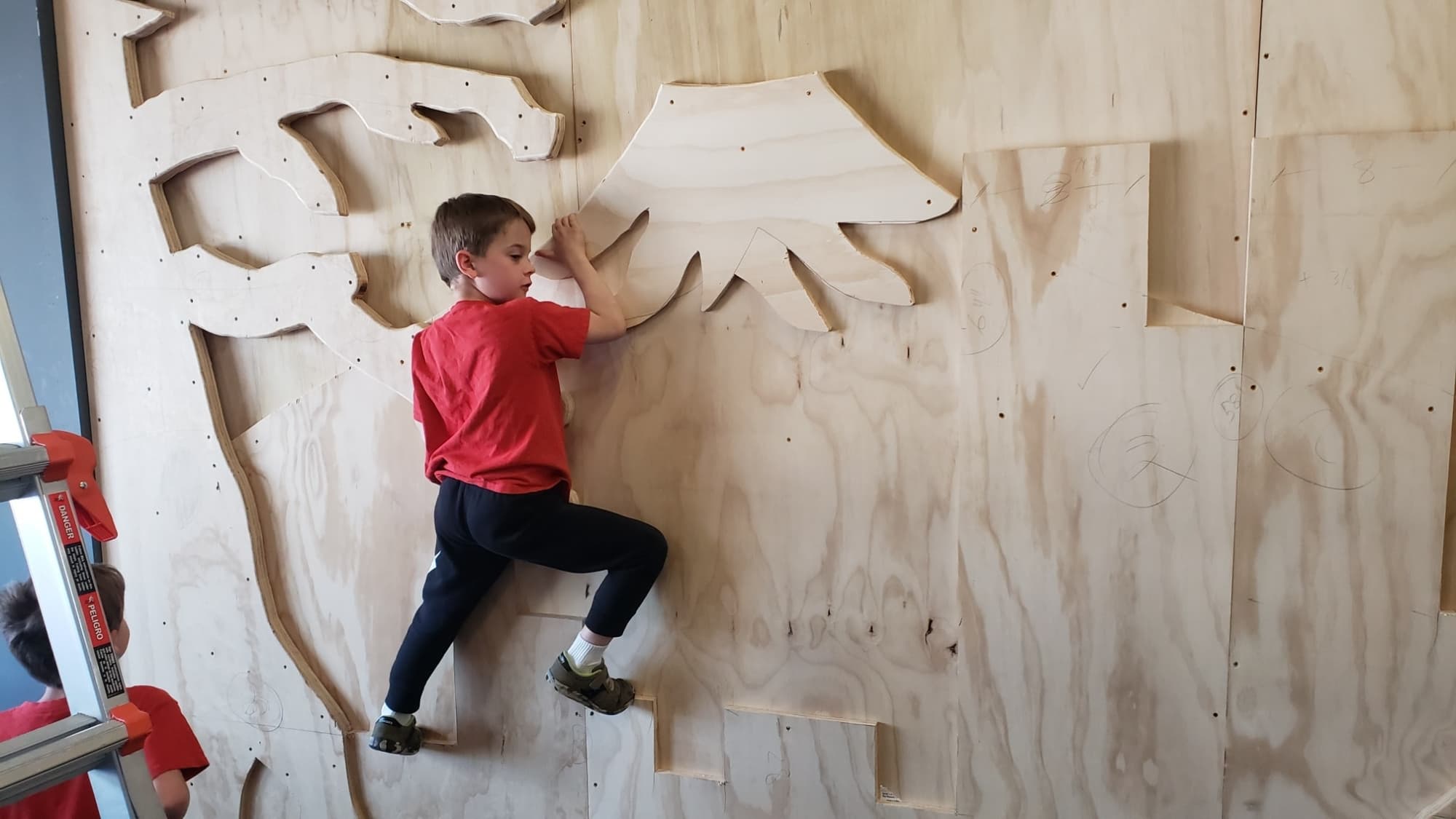 a boy climbing a wall