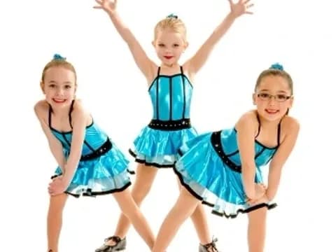 a group of girls in blue dresses