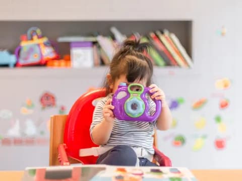 a girl holding a camera
