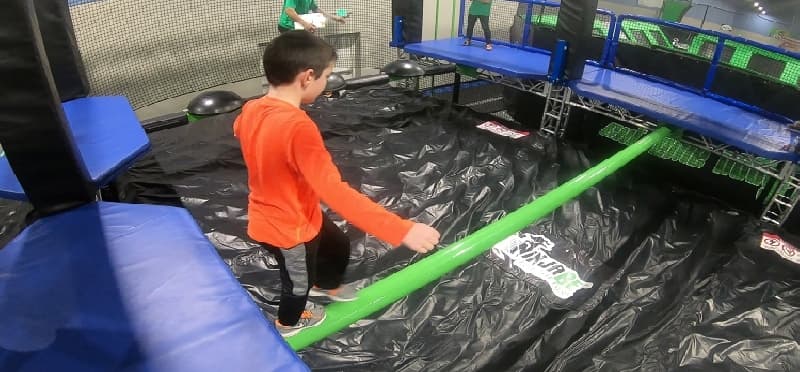 a boy playing with a model train