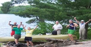 a group of people jumping into a river