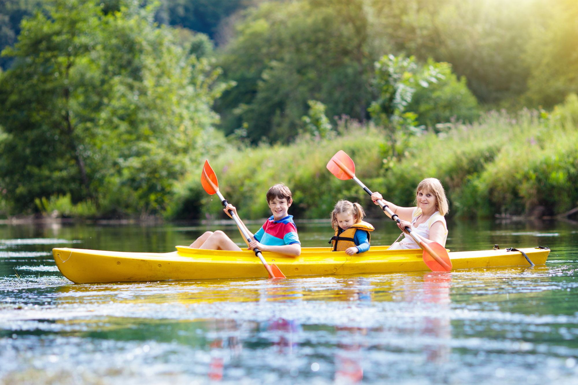 a group of kids in a canoe