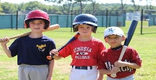 kids holding baseball bats