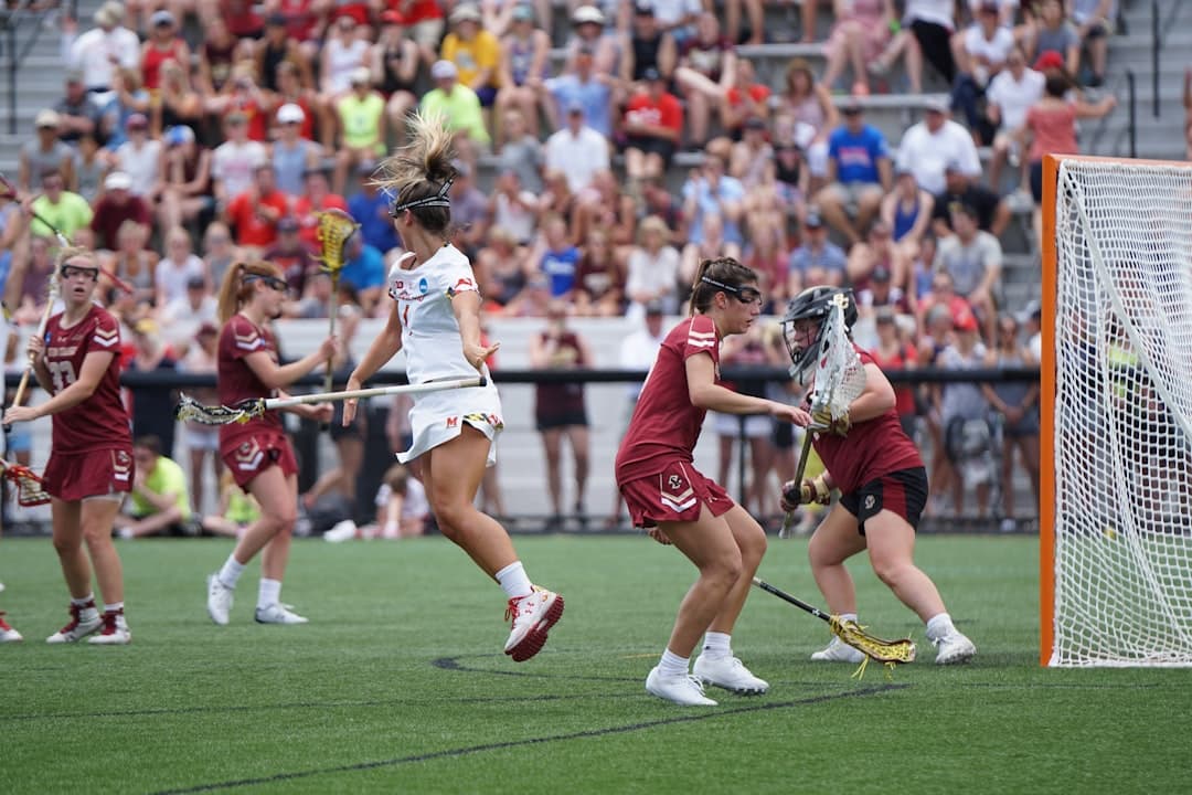 women playing lacrosse at the open field