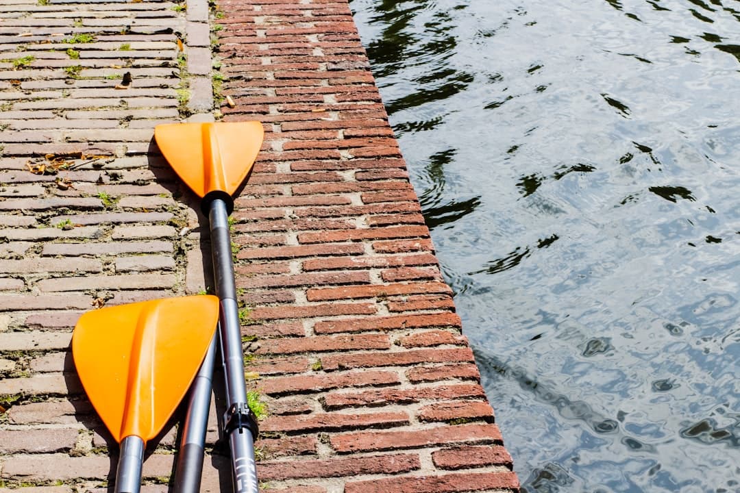 pair of yellow and silver paddles on gray surface