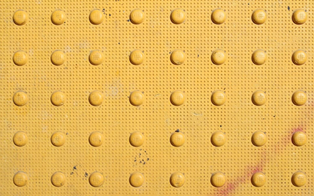 a close up of a yellow wall with lots of dots