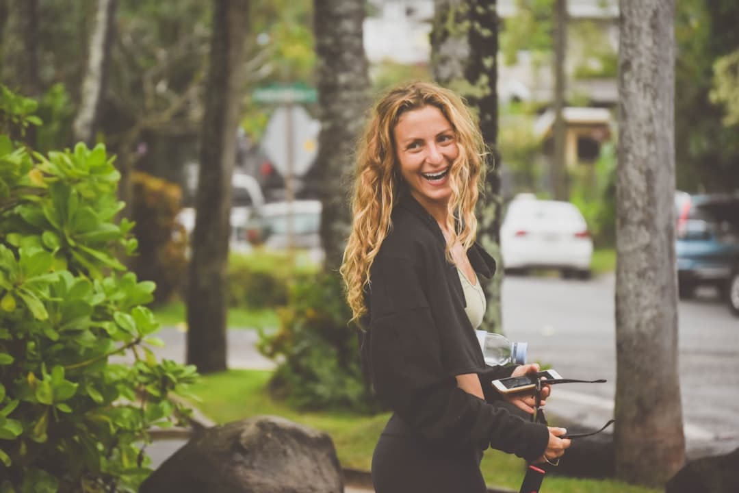 woman in black blazer holding bicycle