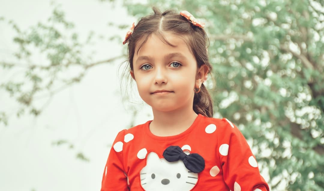 girl in red and white mickey mouse long sleeve shirt