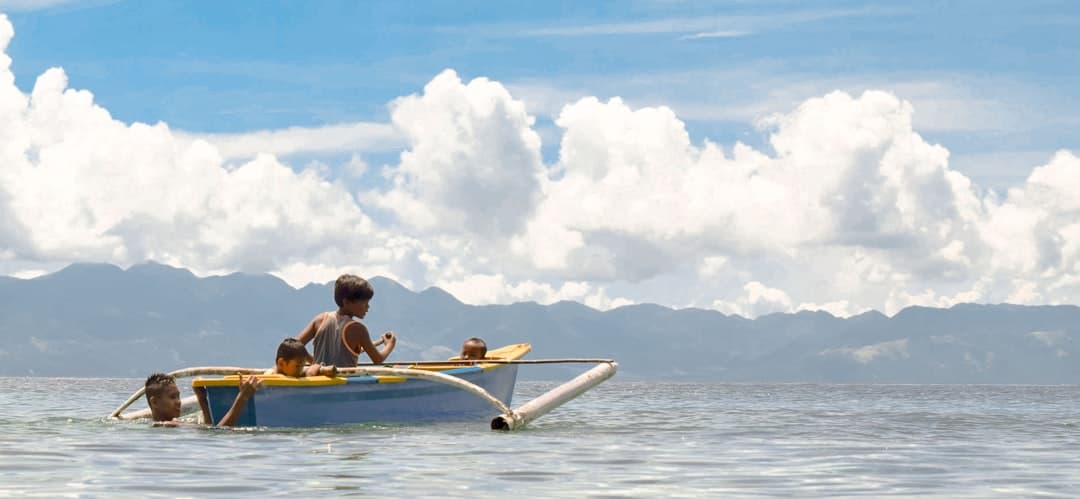 a man and two children in a small boat