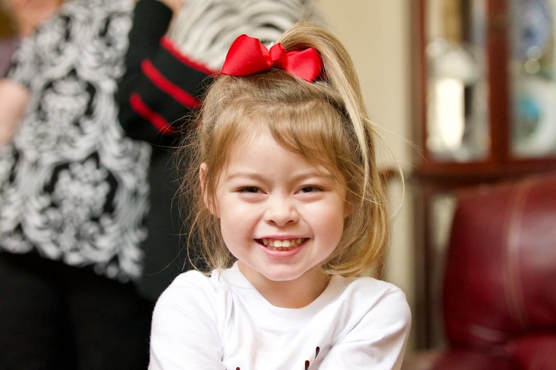 a little girl with a red bow in her hair