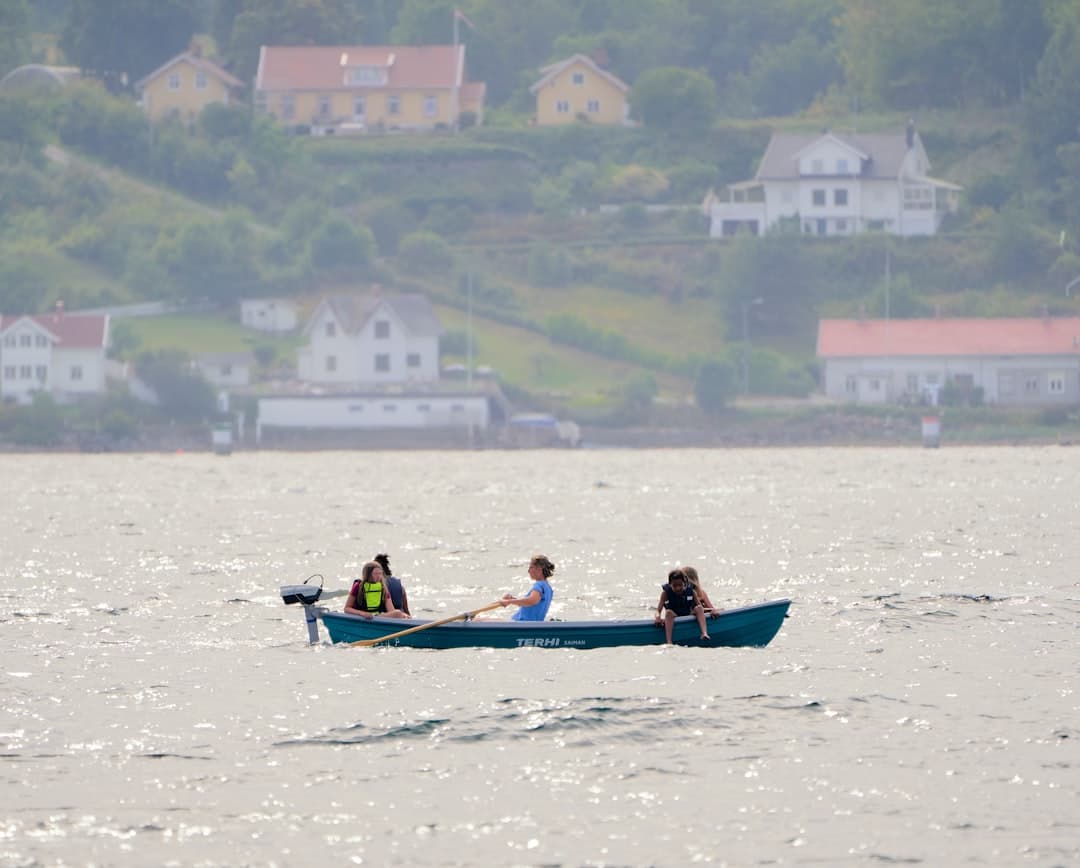 a group of people rowing a boat