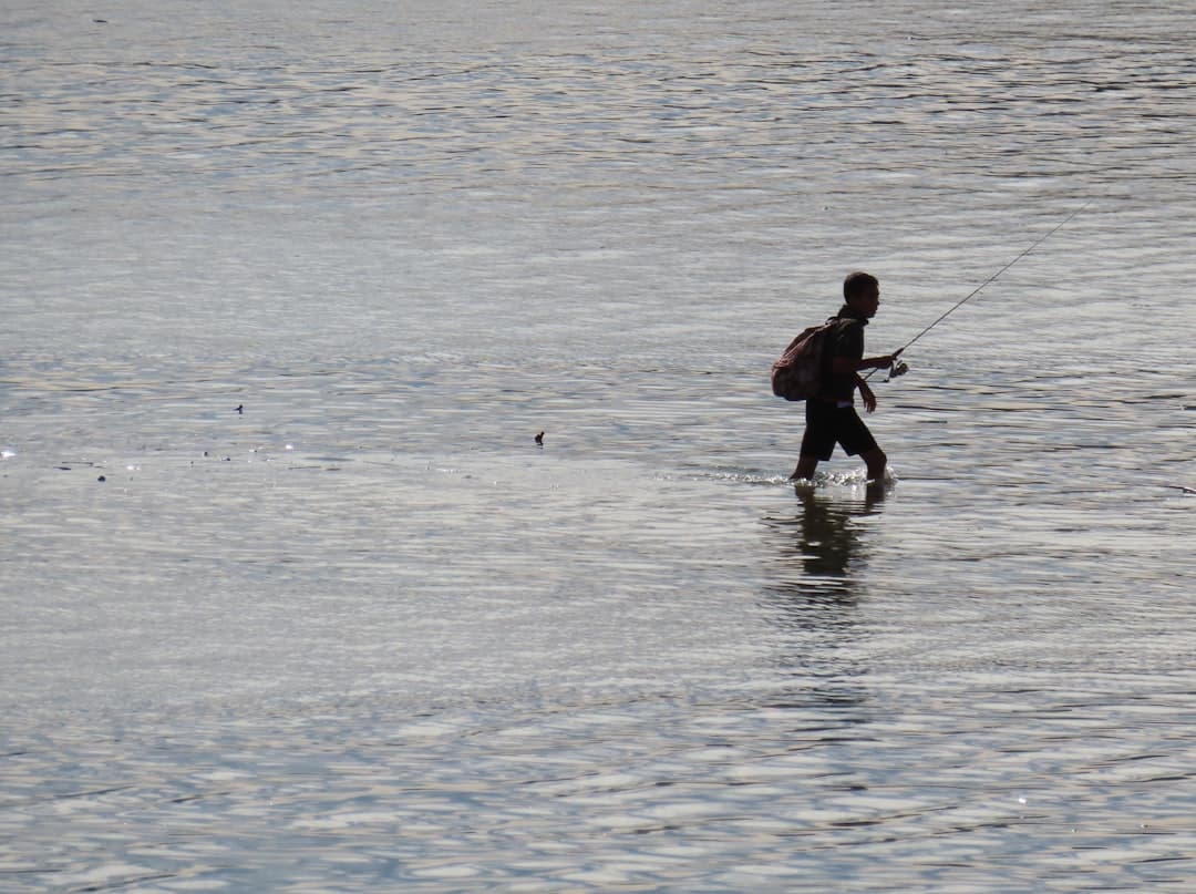 a man walking across a body of water