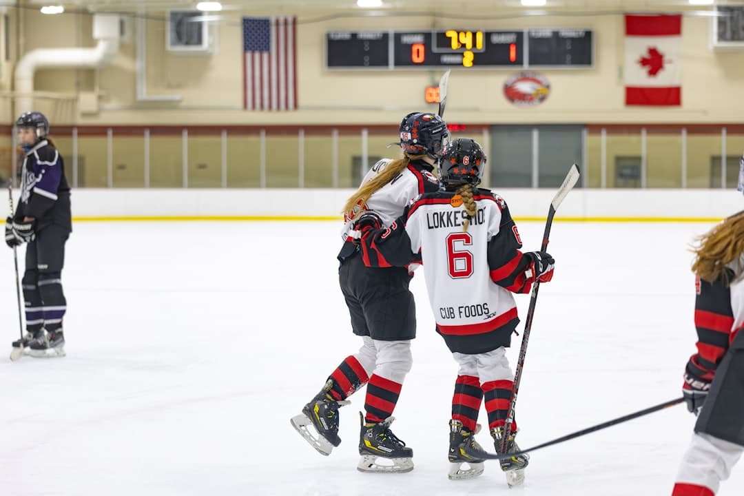 a group of young people playing a game of ice hockey