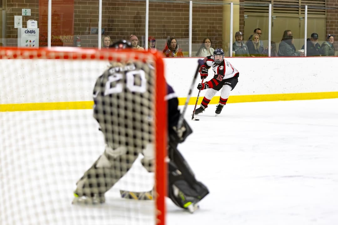 a group of people playing a game of ice hockey