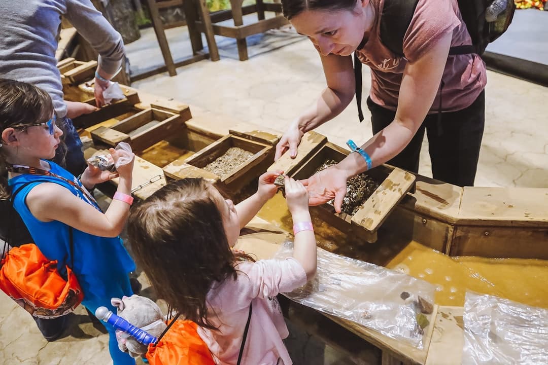 a group of children standing around a wooden box