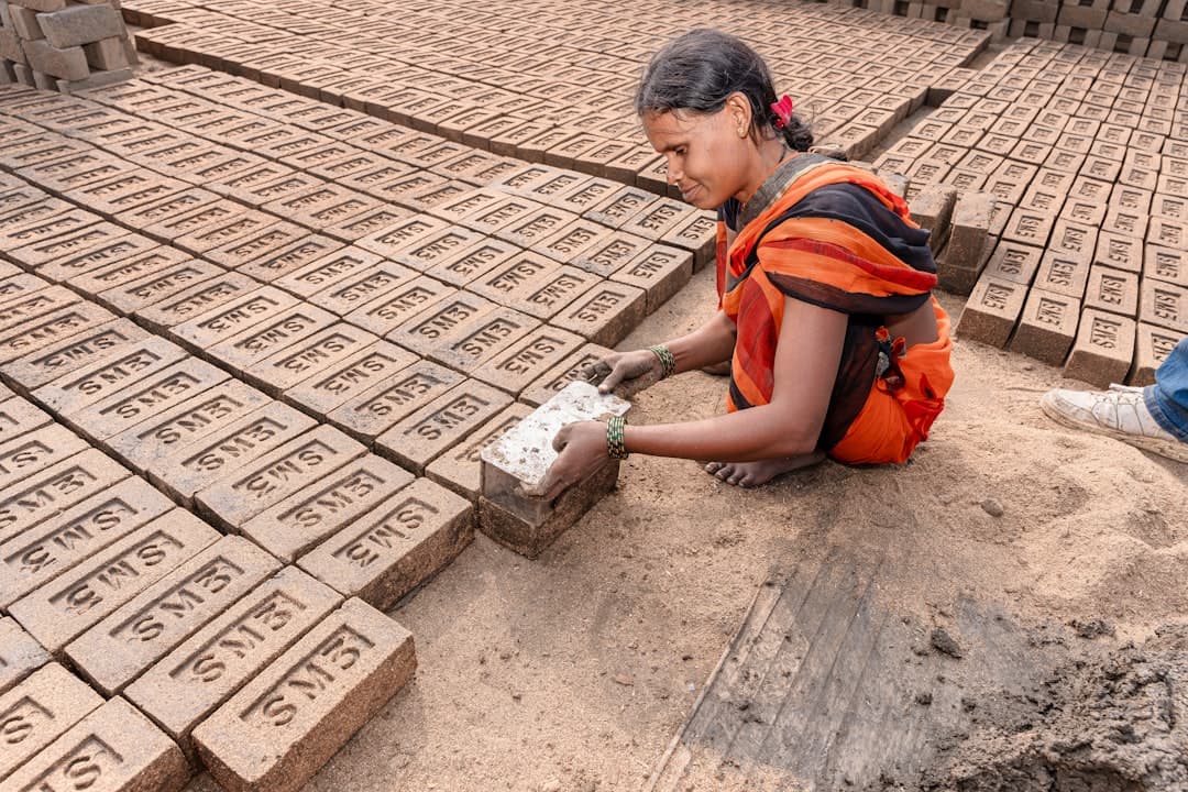 a woman is laying on the ground with bricks