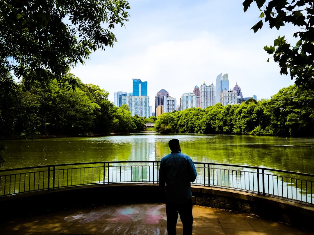 a man standing on a bridge looking at the water