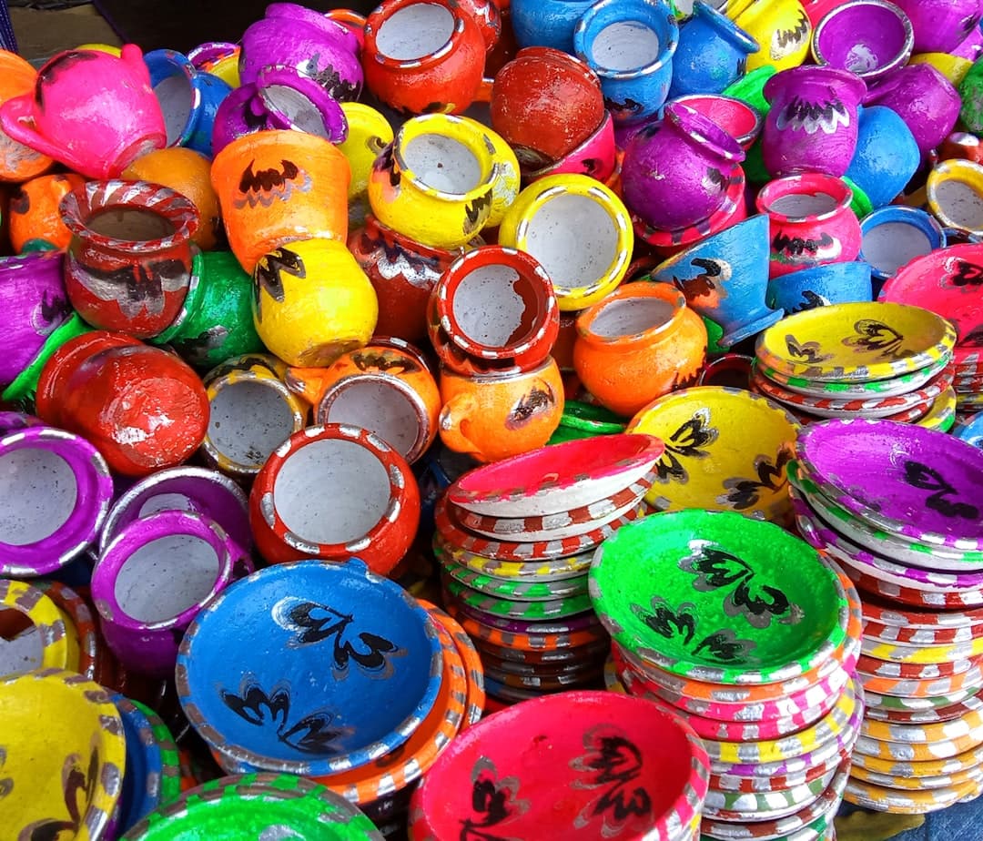 a pile of brightly colored vases sitting on top of each other