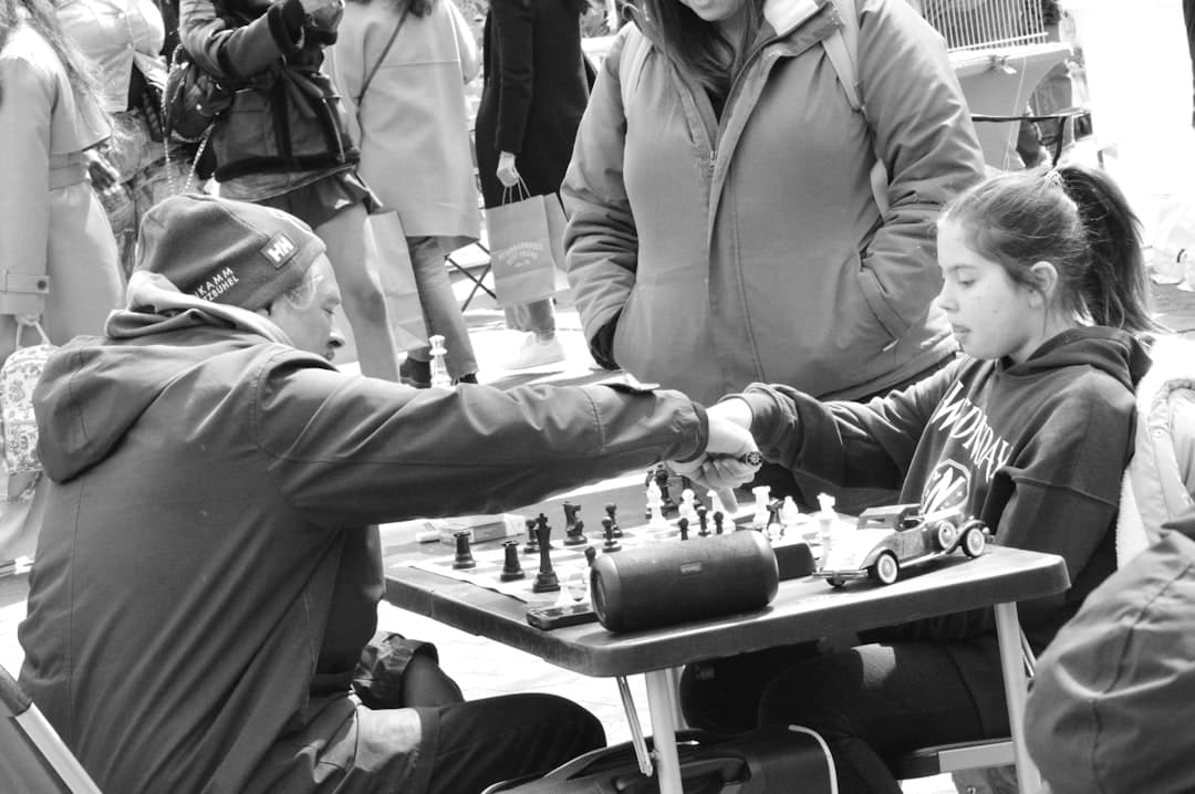a woman playing chess with a child at a table